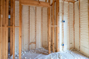 Insulated wall framing with spray foam